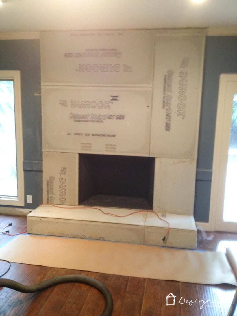 cement boards being attached for DIY concrete fireplace makeover