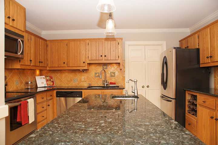 orange oak cabinets in outdated kitchen