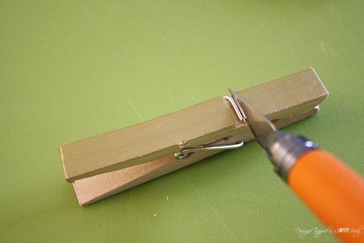 Use your utility knife to expose the metal part of the clothes pin.