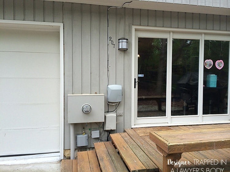 utility boxes hanging on outside of contemporary house by back door