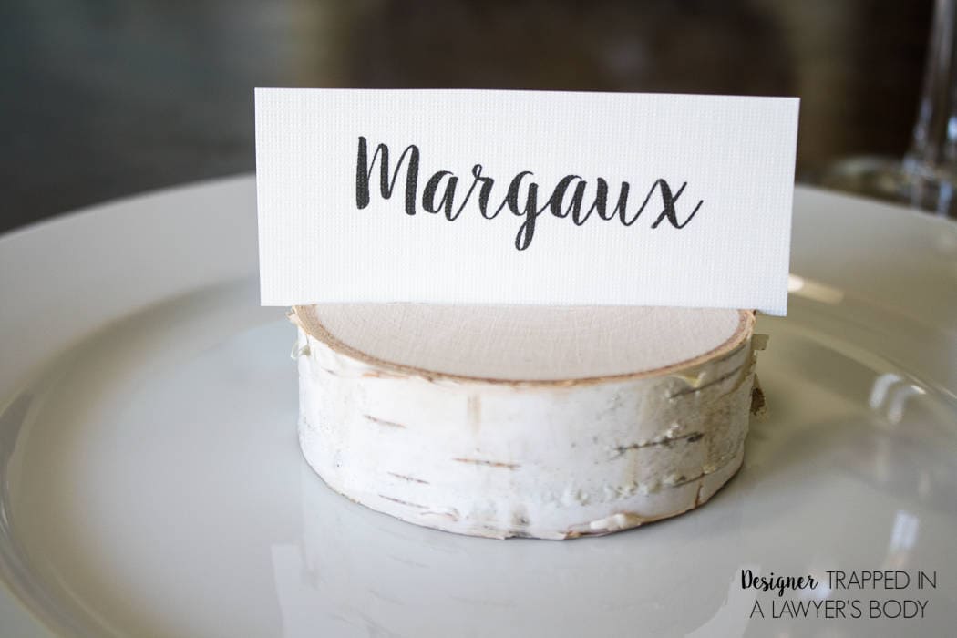 LOVE THESE! Make your own DIY place card holders using wood slices. It takes about 30 seconds per place card holder. Full tutorial from Designer Trapped in a Lawyer's Body.