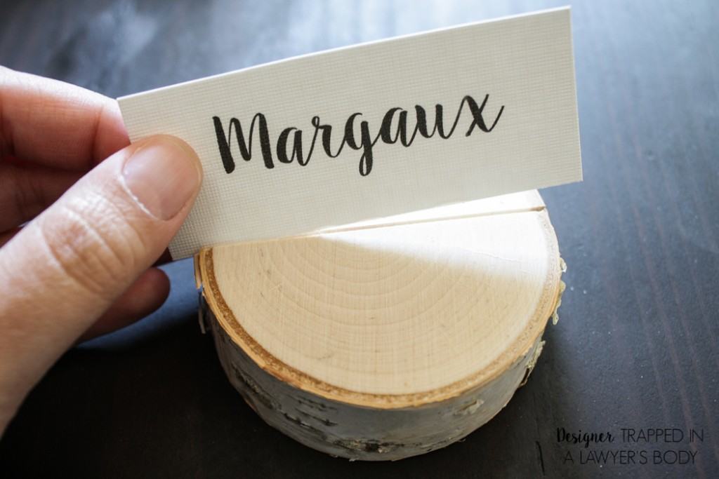 LOVE THESE! Make your own DIY place card holders using wood slices. It takes about 30 seconds per place card holder. Full tutorial from Designer Trapped in a Lawyer's Body. 