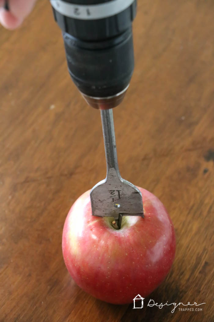 using paddle drill bit to make tea light holder in fresh apple