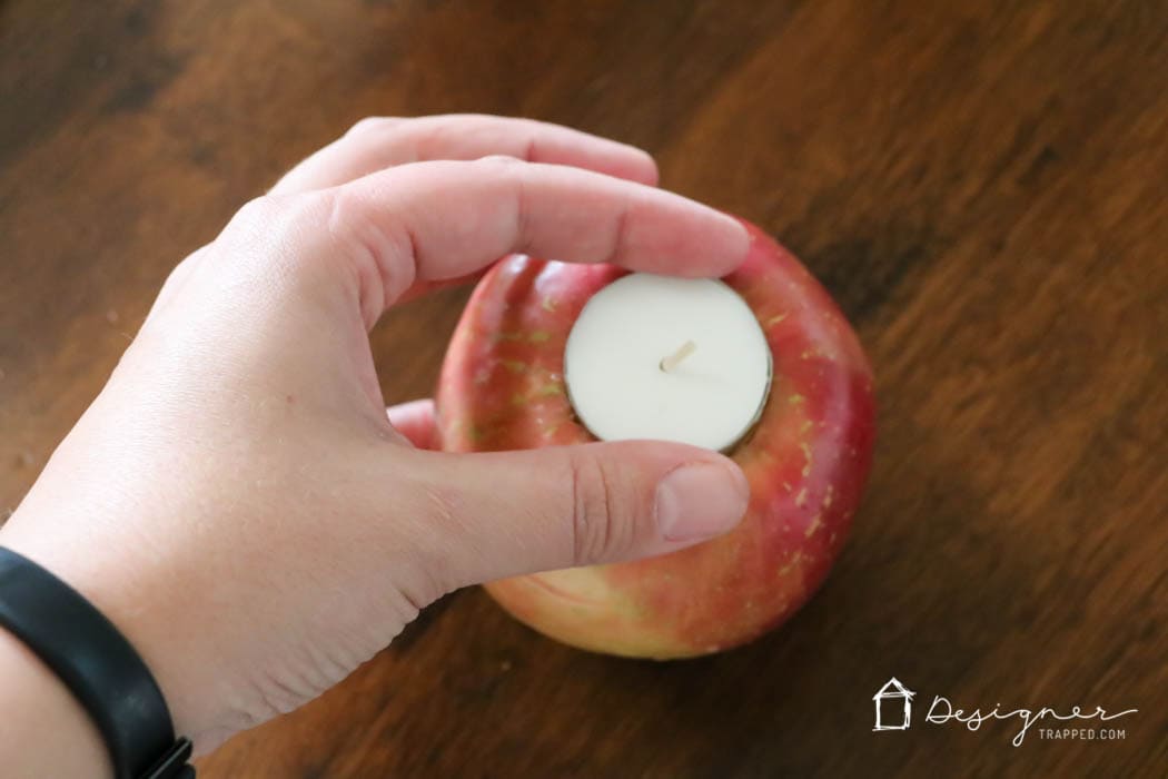 fresh apples turned into tea light candle holders in table centerpiece