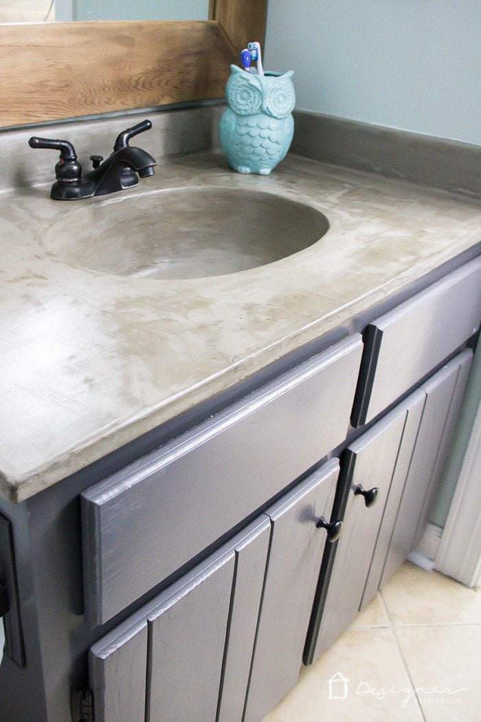 You can update your bathroom vanity without spending a fortune! This DIY vanity update using a concrete overlay with Ardex Feather Finish can be done for around $50 (including a new faucet). Check out the full tutorial!