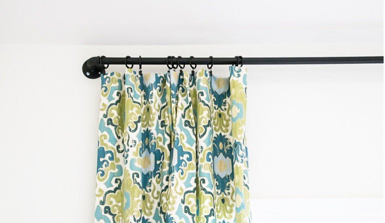 Wow! This blogger shows you how easy it is to make a gorgeous DIY curtain rod out of pipe in less than 10 minutes! | DIY curtain rod from pipe | designertrapped.com