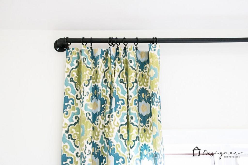 Wow! This blogger shows you how easy it is to make a gorgeous DIY curtain rod out of pipe in less than 10 minutes! | DIY curtain rod from pipe | designertrapped.com