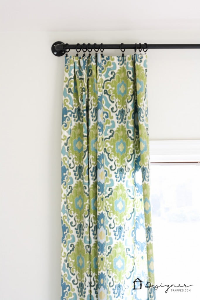 Wow! This blogger shows you how easy it is to make a gorgeous DIY curtain rod out of pipe in less than 10 minutes! | DIY curtain rod from pipe | designertrapped.com