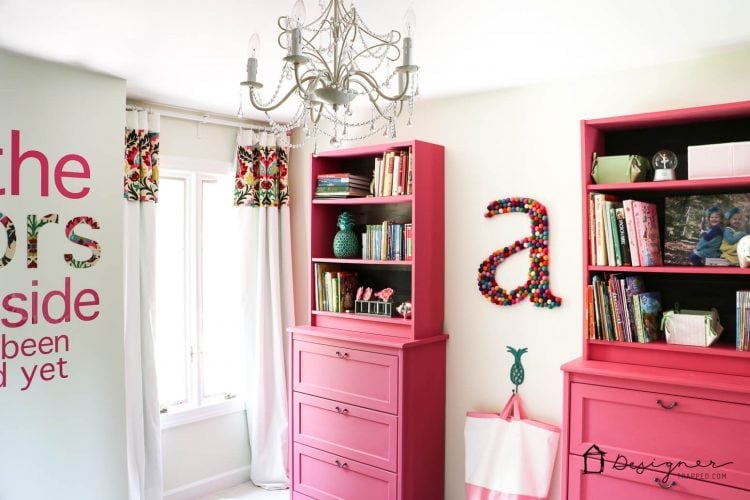 A pink and white room featuring pink IKEA Billy book case DIY IKEA hacks. 