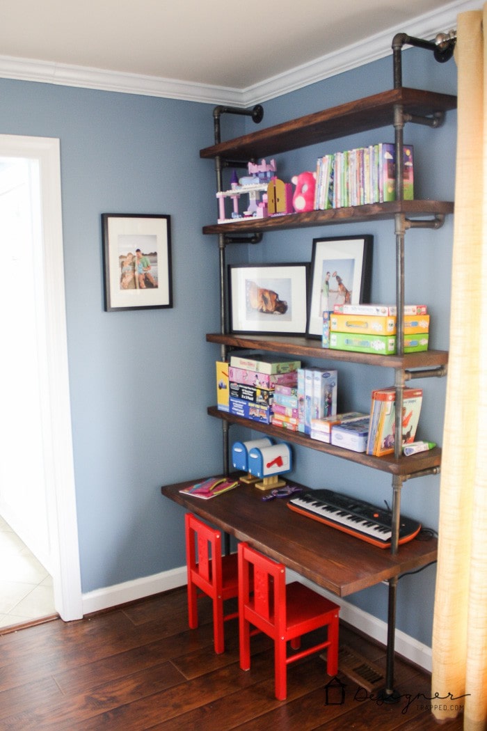 playroom with pipe bookshelves