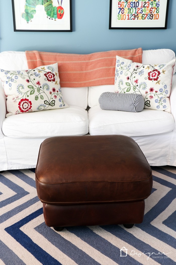 restored leather ottoman in colorful 