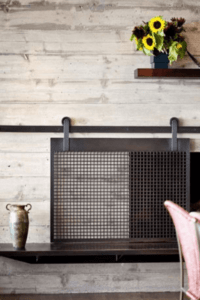 OMG, this sliding fireplace screen is amazing! Best of all, this blogger's tutorial teaches you how to make a barn door style fireplace screen without having to know how to weld. I can't wait to make one for my house ASAP.