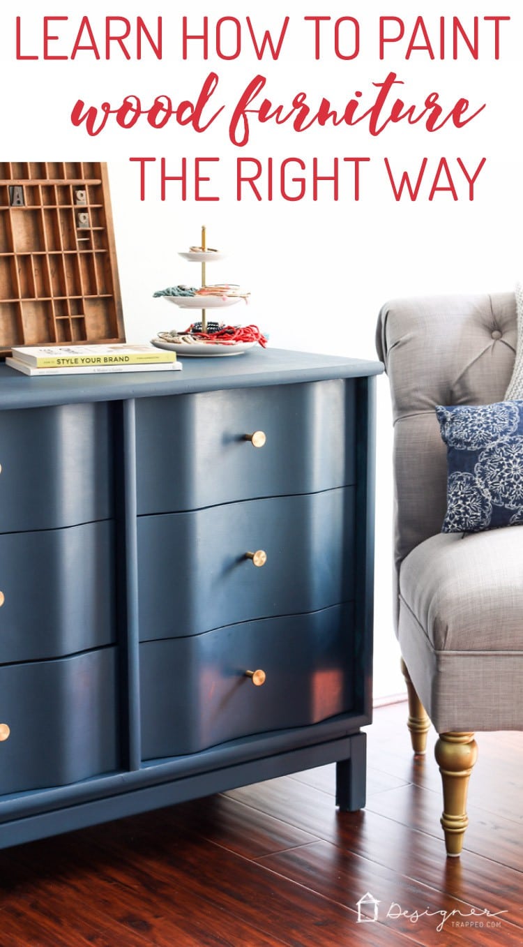 A long graphic of a blue painted dresser with a wavy front, gold hardware, and a grey tufted chair nearby. "DesignerTrapped.com" is in the lower right-hand corner, and the text above reads, "Learn How to Paint Wood Furniture the Right Way."