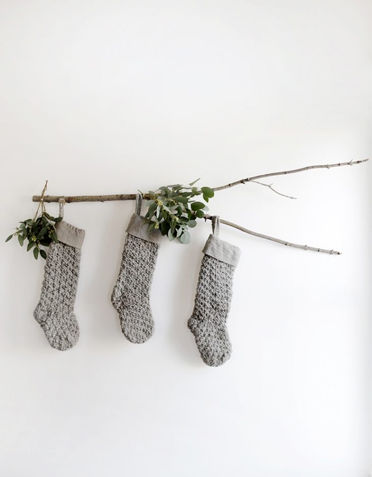 branch with grey knitted stockings