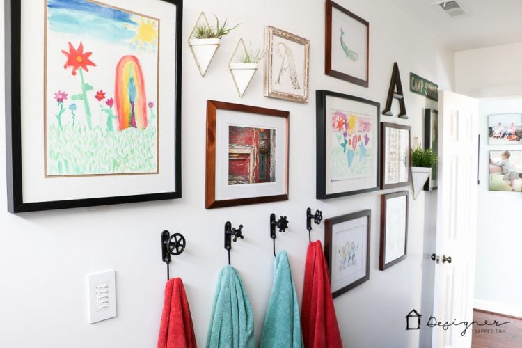 colorful bathroom gallery wall in kid's bathroom