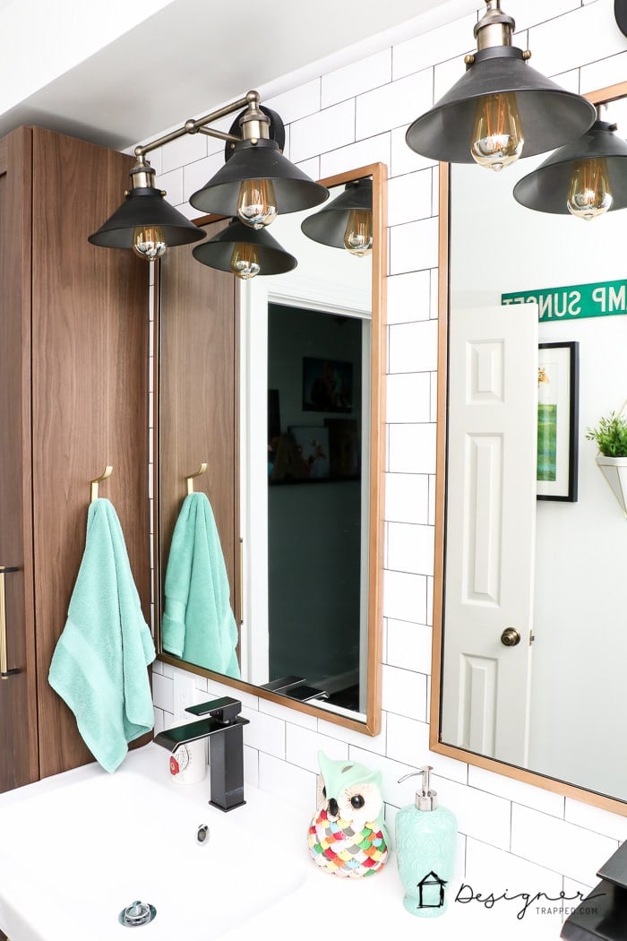 WOW, WOW, WOW! This DIY bathroom remodel is by far one of the best I have seen, and they REALLY did all the work themselves! I love the floor to ceiling subway tile, the black slate tile floor and the penny tile accents. And that floating vanity is amazing.