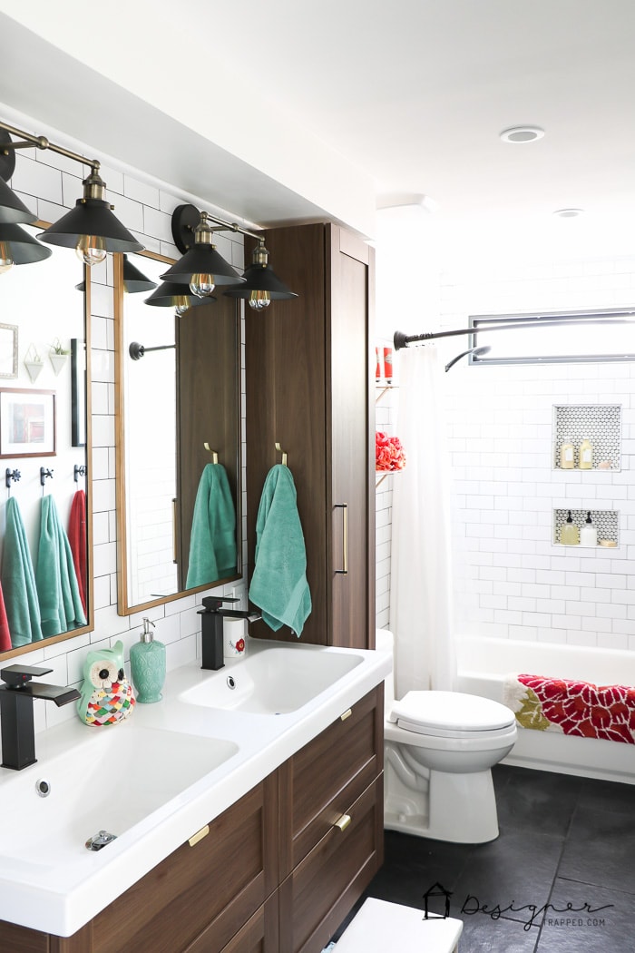 WOW, WOW, WOW! This DIY bathroom remodel is by far one of the best I have seen, and they REALLY did all the work themselves! I love the floor to ceiling subway tile, the black slate tile floor and the penny tile accents. And that floating vanity is amazing. 