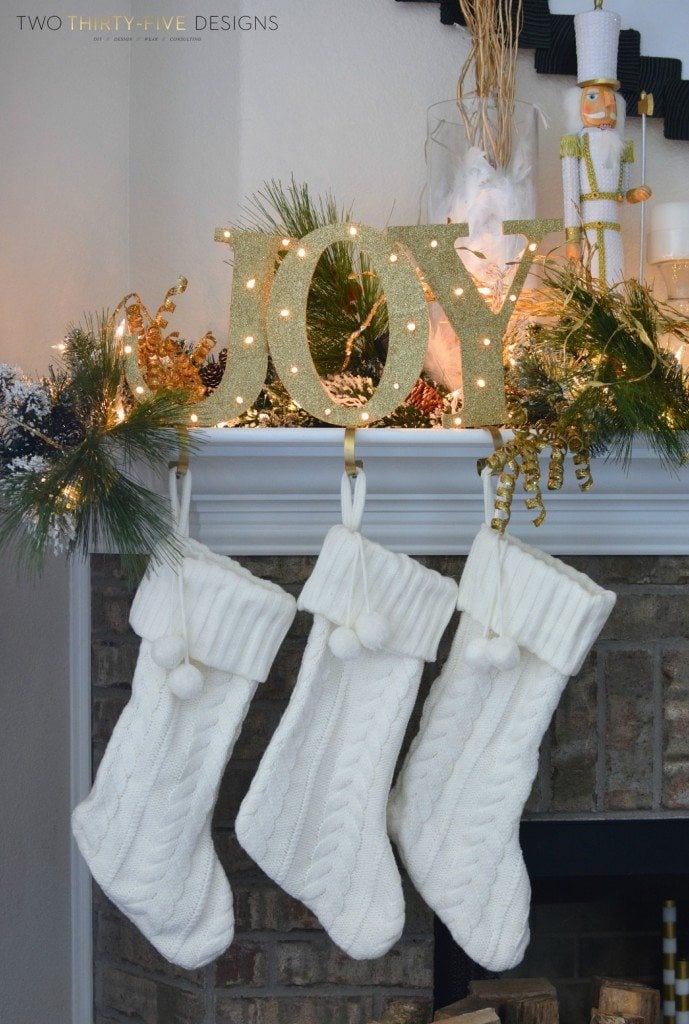gold "joy" stocking hangers with lights