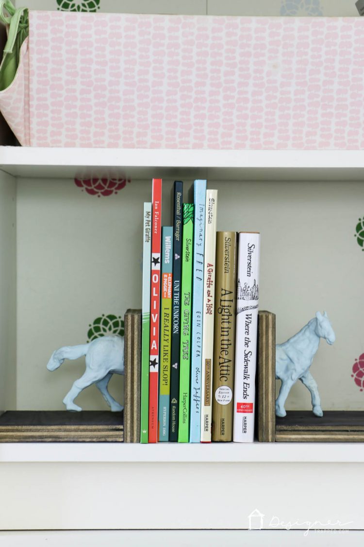 Make these DIY bookends for a high-style look on a tiny budget yourself! It's a fun and easy project. No power tools required! Check out the full blog post to see how I made these DIY bookends for $1 out of pocket!