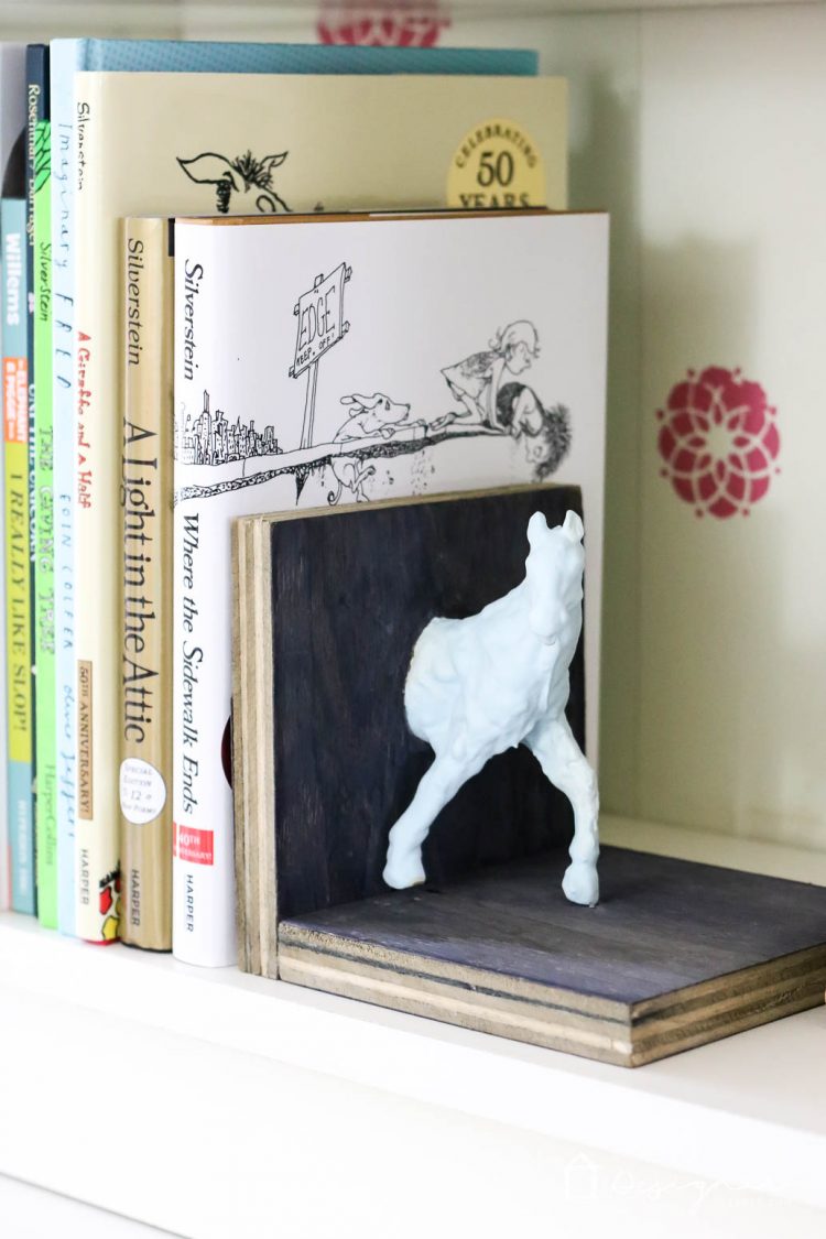 Make these DIY bookends for a high-style look on a tiny budget yourself! It's a fun and easy project. No power tools required! Check out the full blog post to see how I made these DIY bookends for $1 out of pocket!