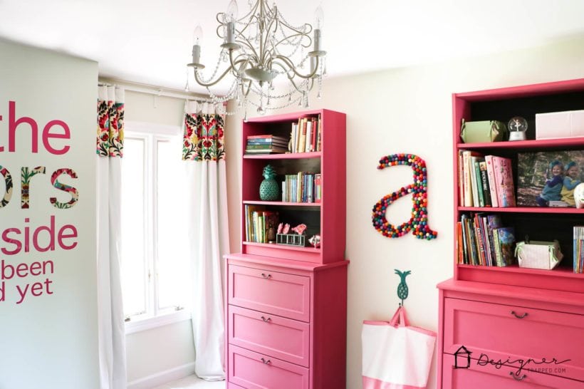 girls bedroom with pink painted IKEA bookcases