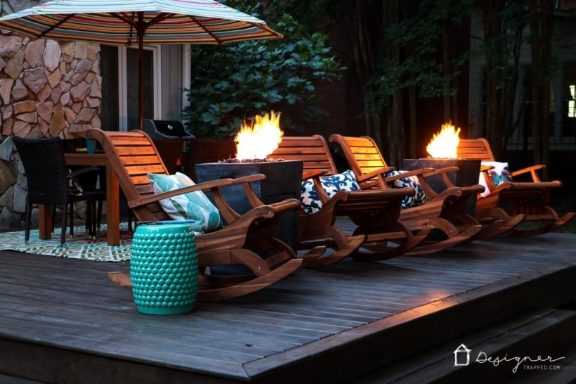 teak chairs and fire columns on back porch at dusk