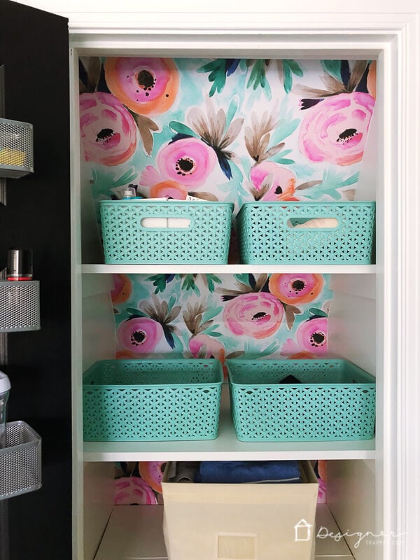 photo of linen closet organization using bins to store similar items