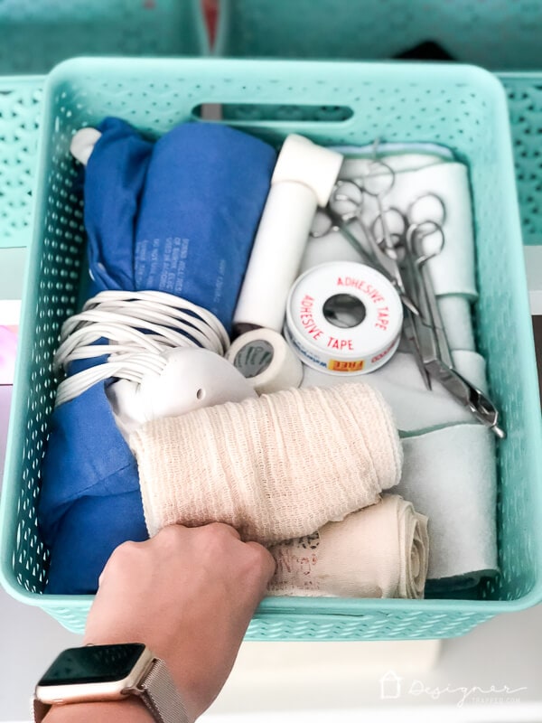 first aid supplies neatly stored in containers in bins