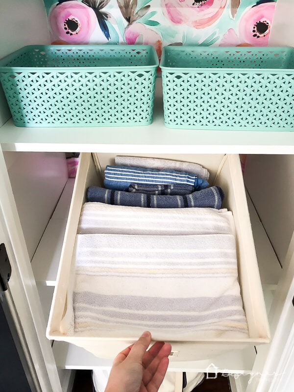 photo of towels stored in canvas bins