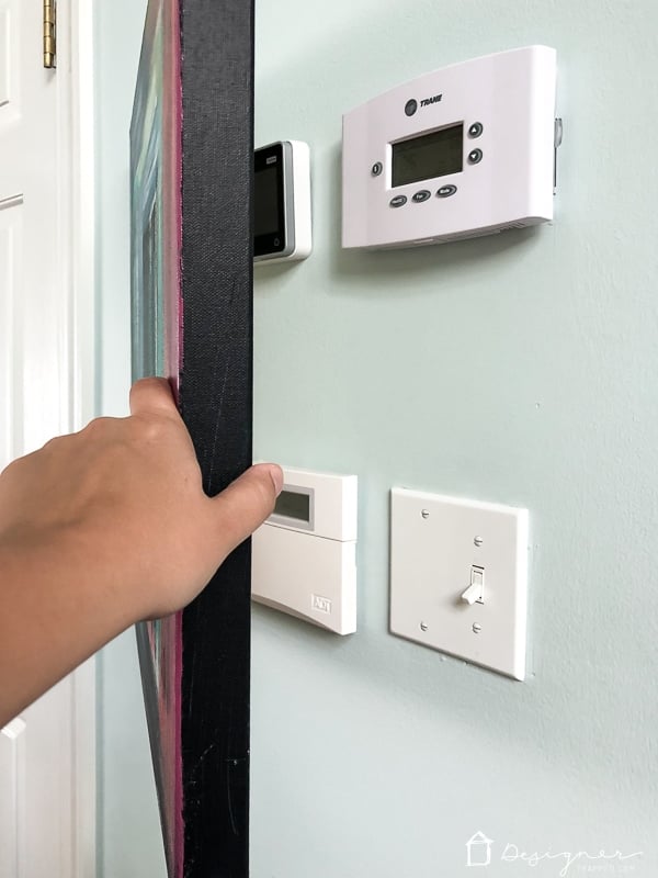 art hiding thermostat and alarm panel