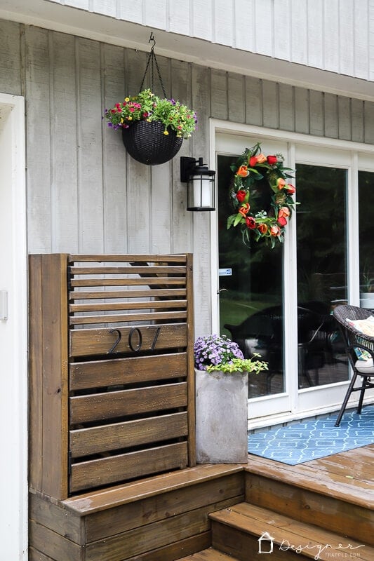 modern DIY utility box cover with door outside a contemporary home