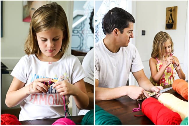 kids making yarn pom poms for DIY wreath by Tasha Agruso of Kaleidoscope Living