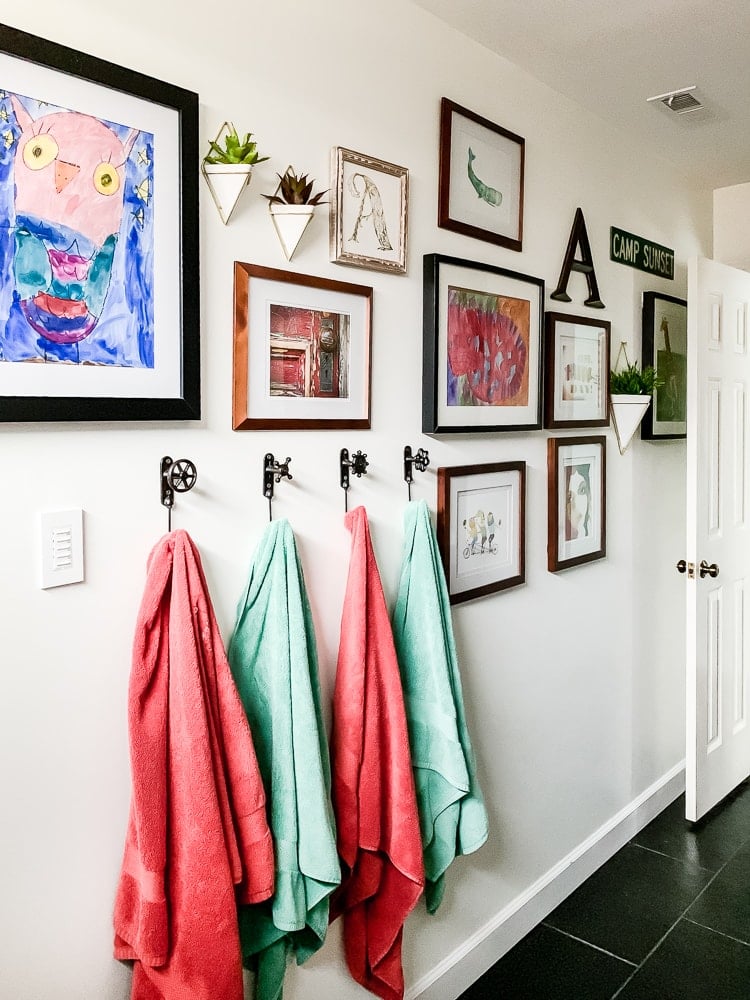 colorful gallery wall in bathroom