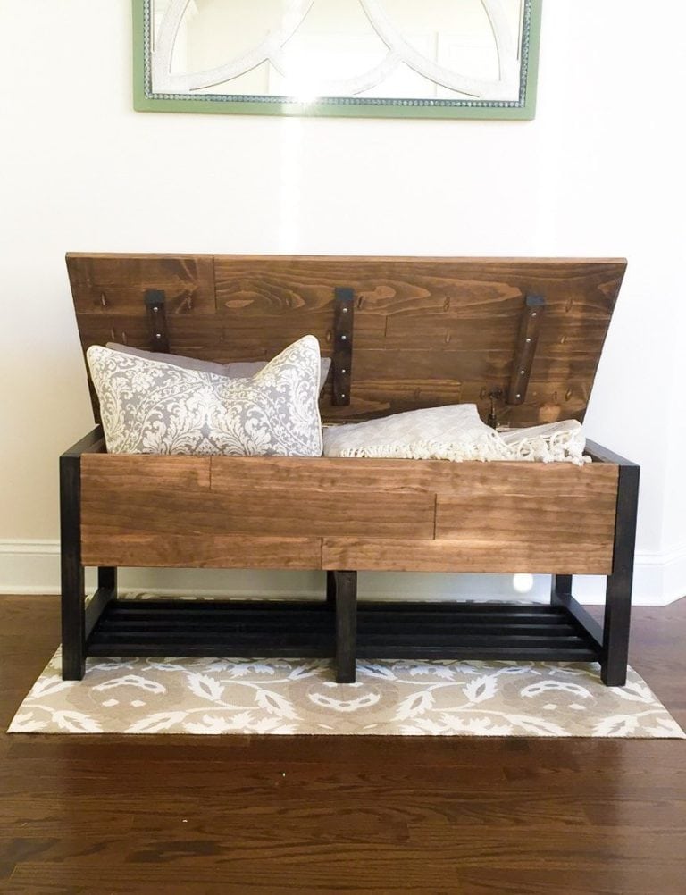 wood storage bench with metal legs and pillows inside