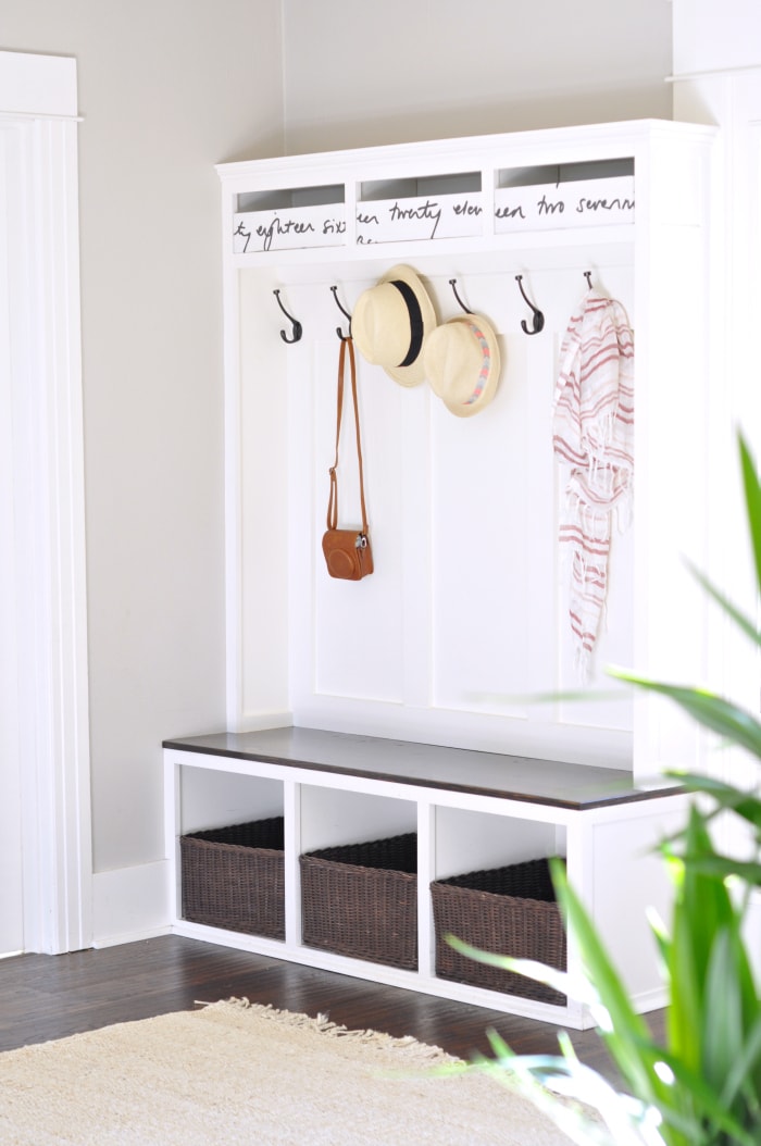 white mudroom bench with hooks and cubbies