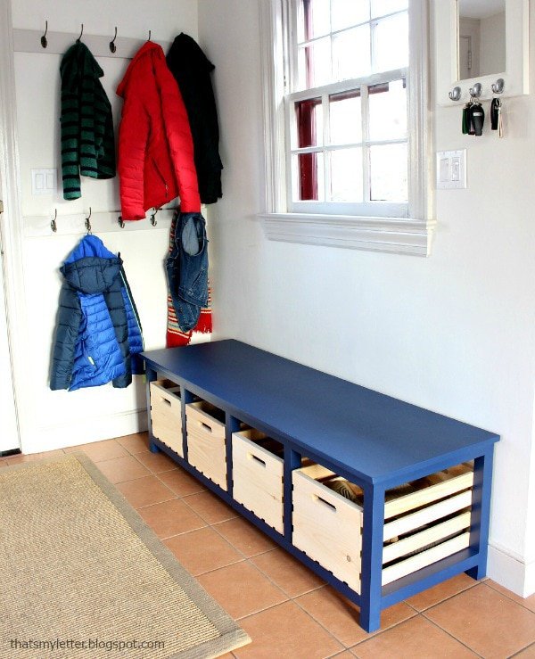 blue entryway bench with storage crates