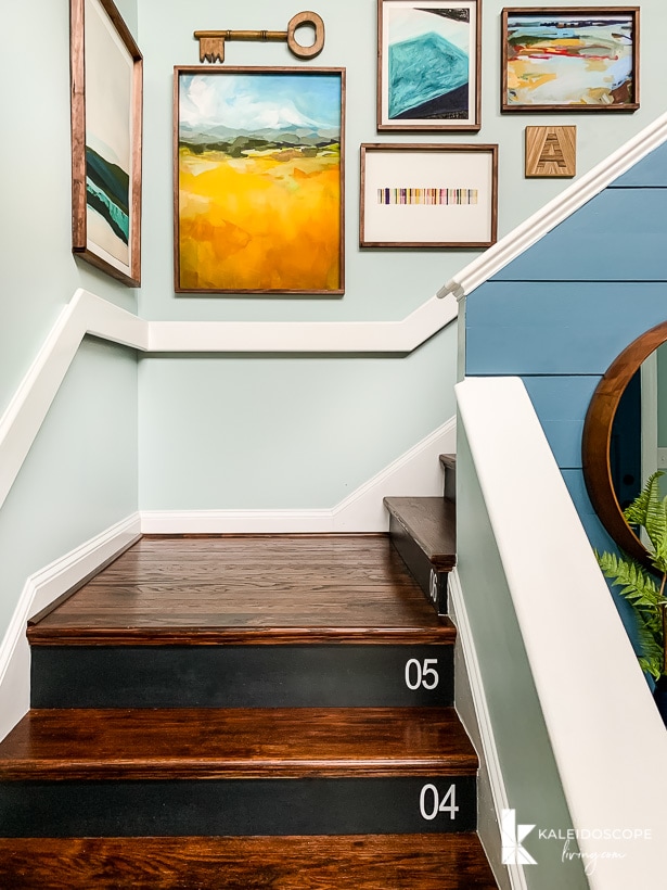 wood staircase with colorful art arrangement