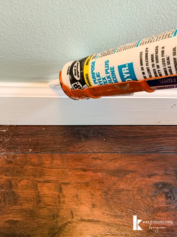 DAP Alex Plus caulking along baseboard