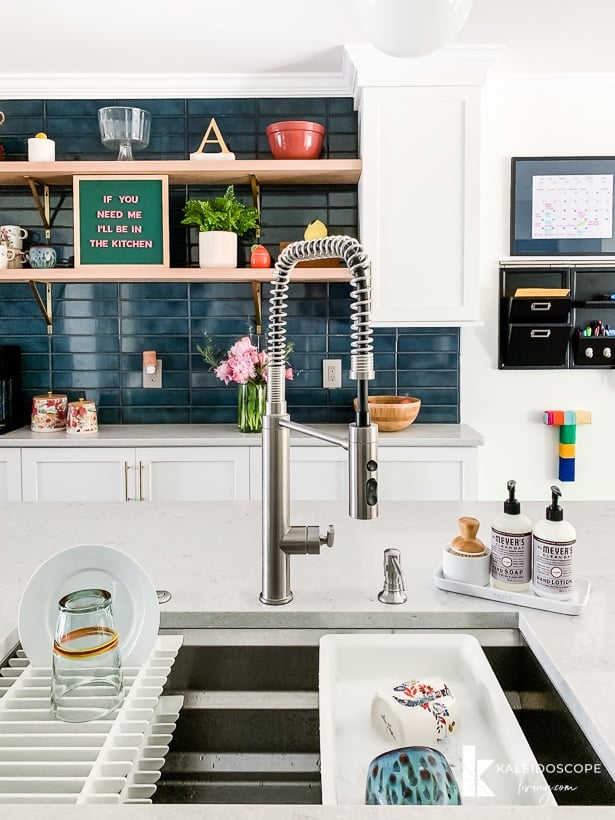 kohler prolific sink in white and teal kitchen