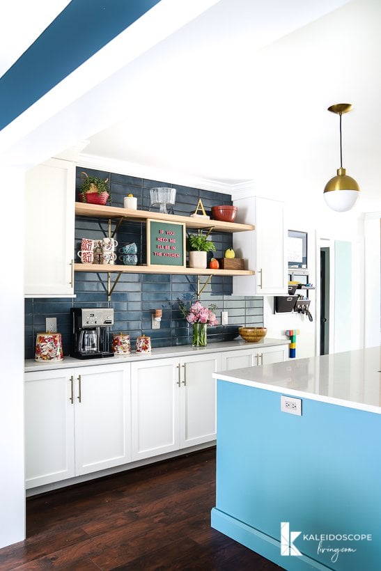 white and teal kitchen open to dining room