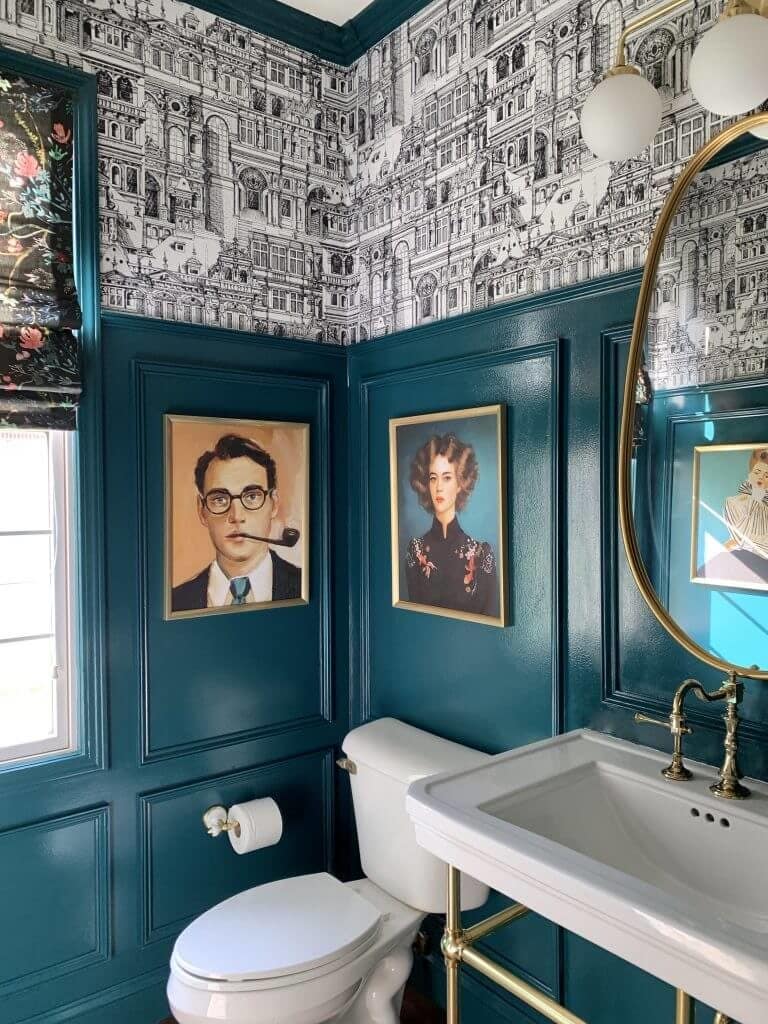 picture molding on dark teal walls with black and white graphic wallpaper above it 