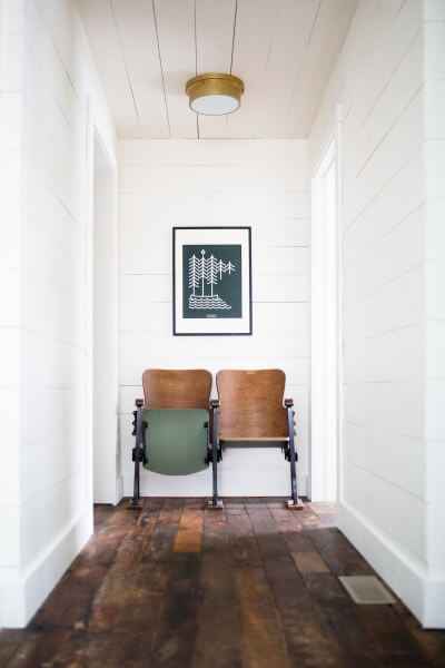shiplap hallway with antique theater chairs