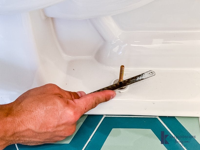 trimming toilet bolts with a hack saw