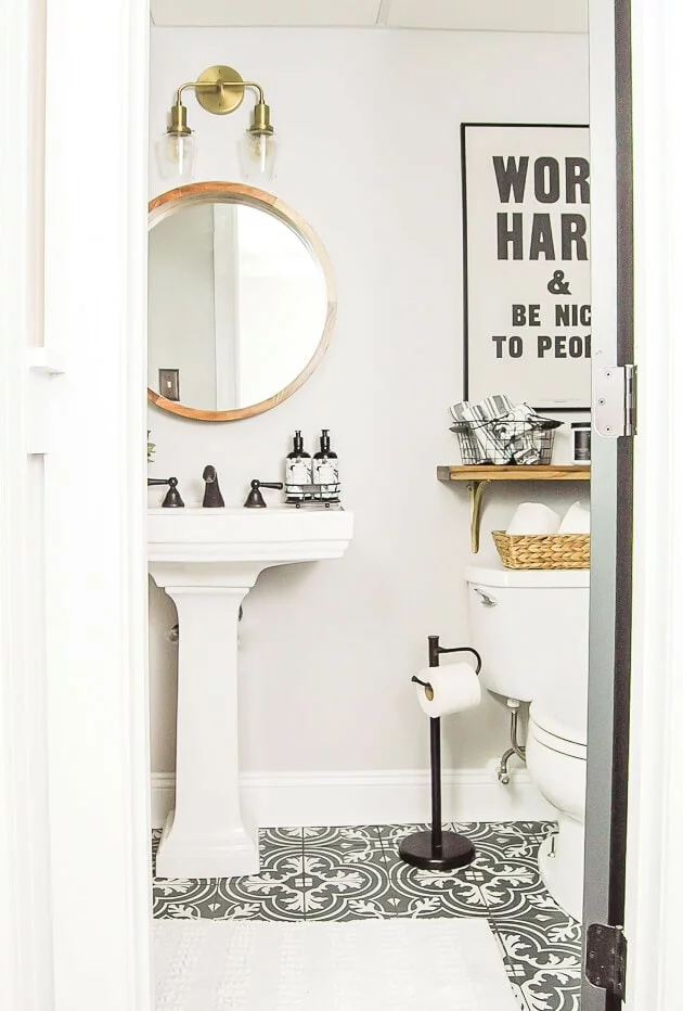 neutral bathroom with wood accents and typography poster