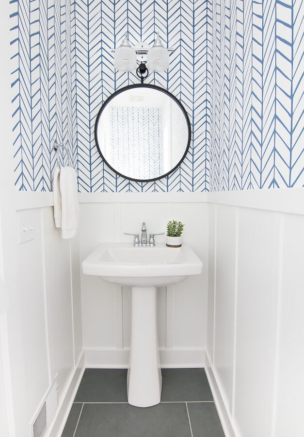powder room with chevron line wallpaper and white bead board