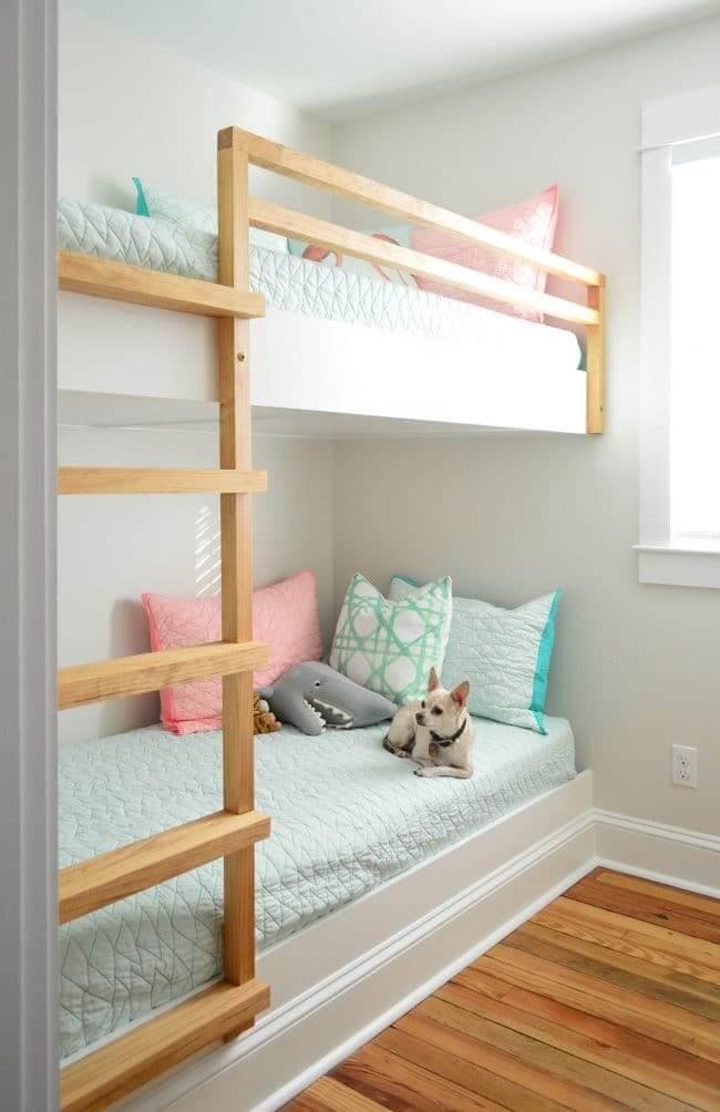 white bunk beds with natural wood ladder and rails