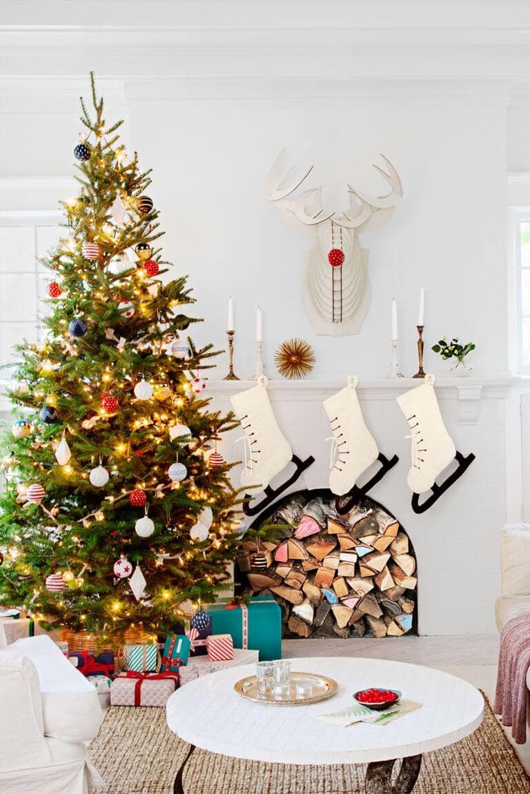 ice skate stockings and cardboard reindeer bust with colorful chalked wood in fire place