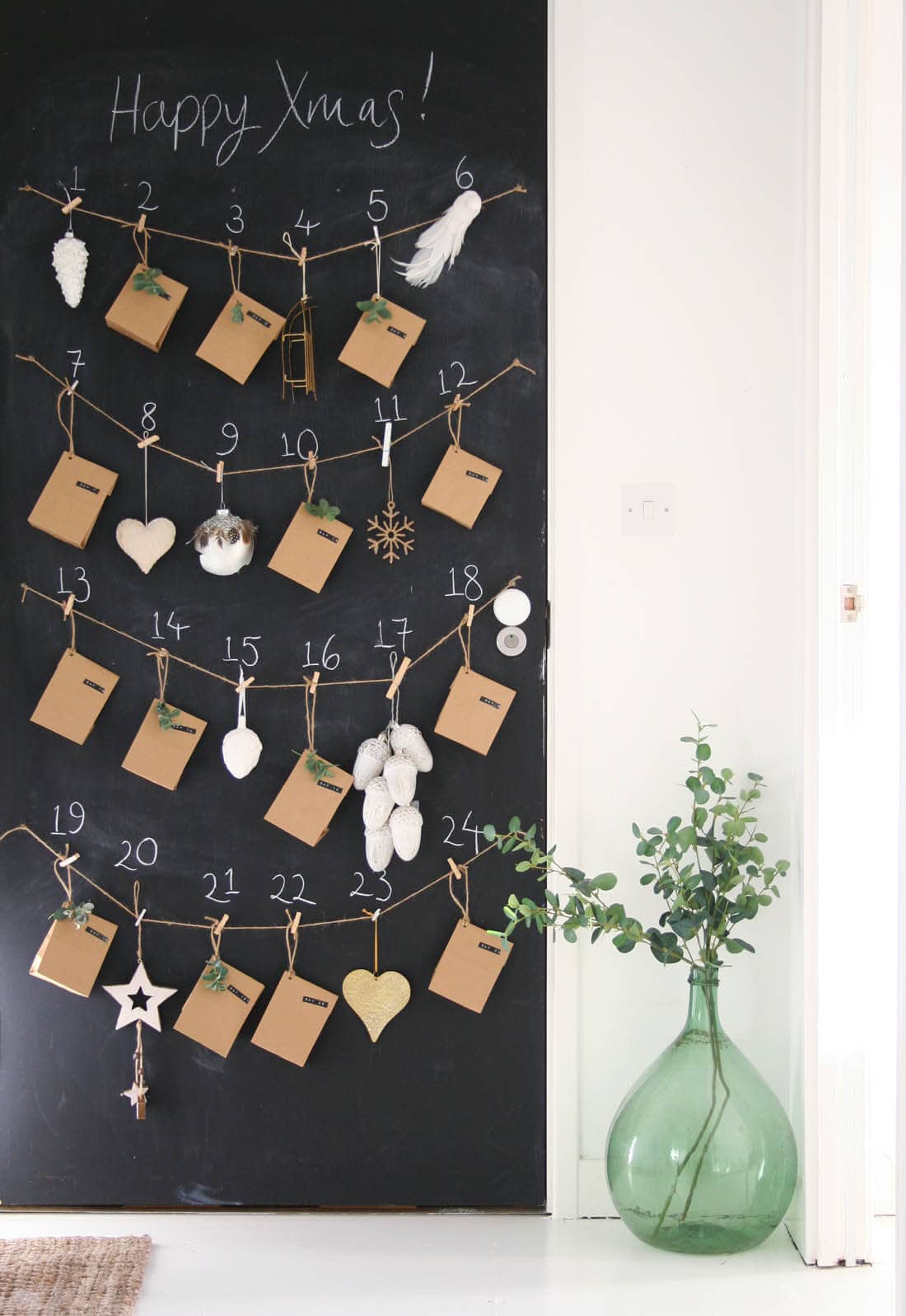 craft bag envelopes and ornaments on chalkboard advent calendar