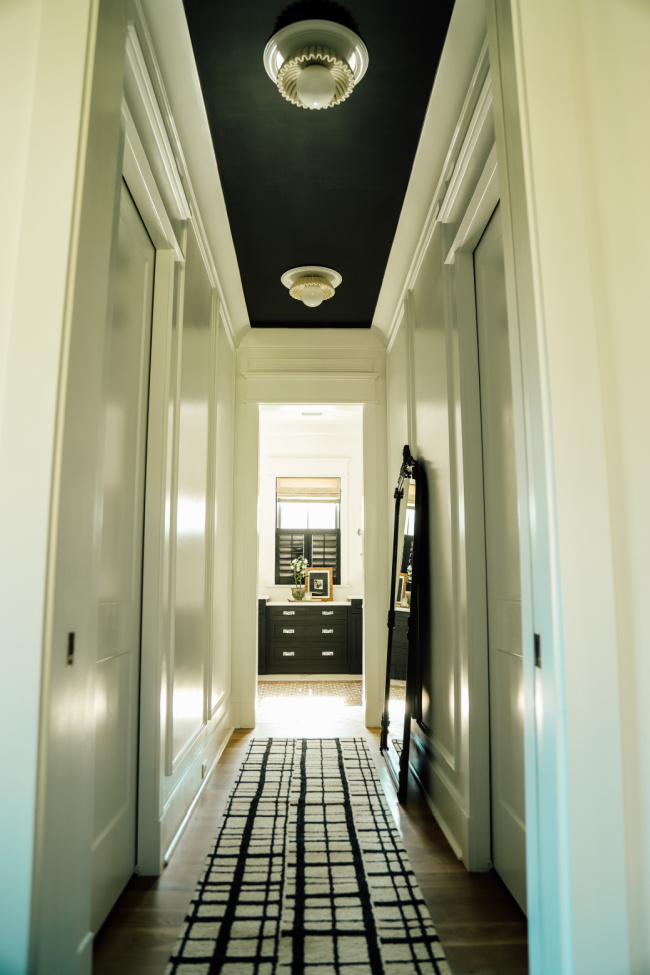 hallway with box molding and black ceiling