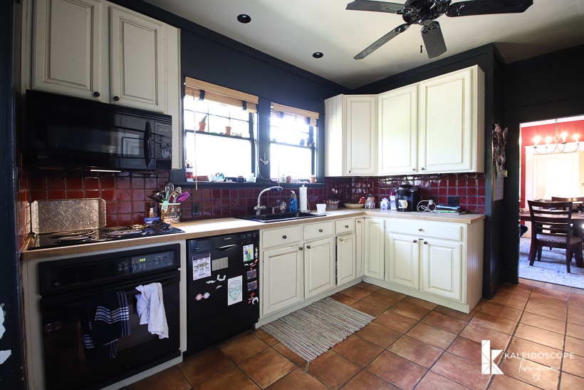 before picture of kitchen with cream cabinets and black walls